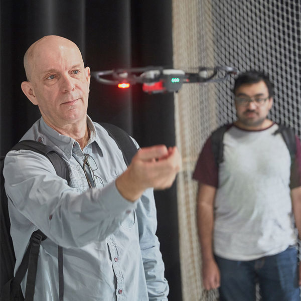 Image of man flying drone