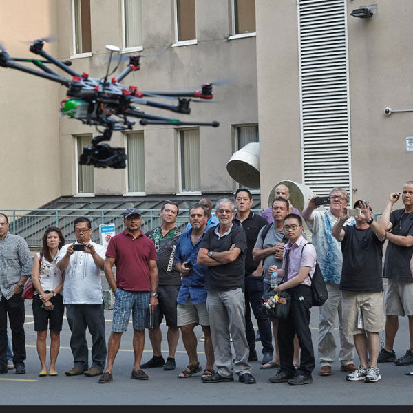 Image of crowd of people watching a drone in flight