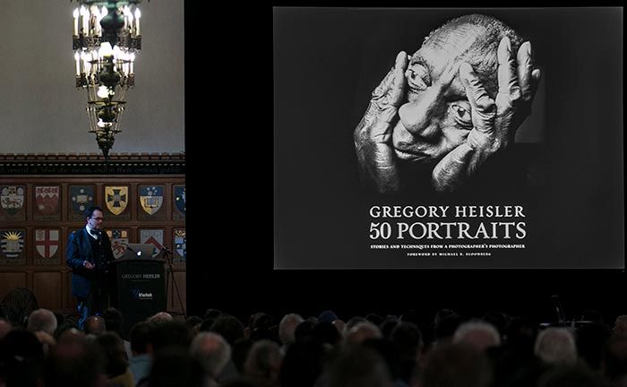 Image of man standing on stage taking about Photographer Gregory Heisler's Portrait Photography