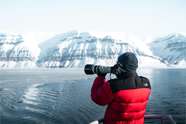 Man taking photo with Canon camera