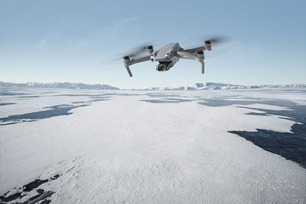 Image of drone flying above frozen lake