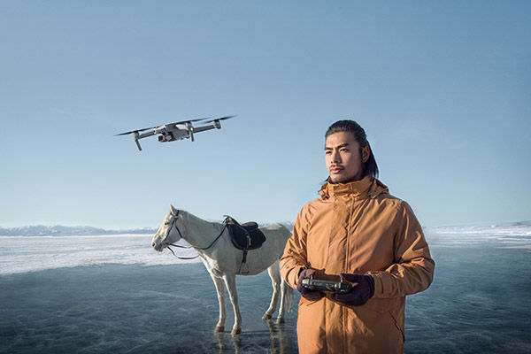 Image of drone operator on frozen lake