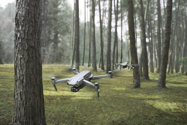 Image of two drones flying in jungle