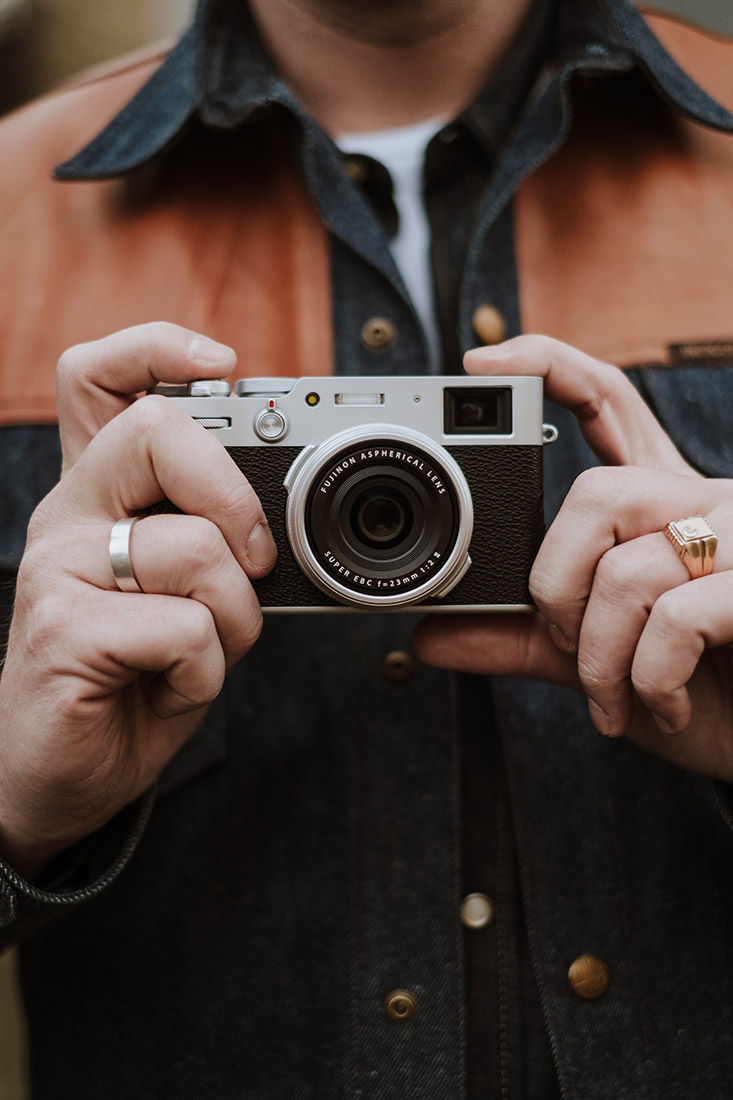 Lifestyle image of man holding camera