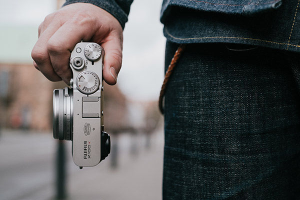 Lifestyle close up image of holding camera