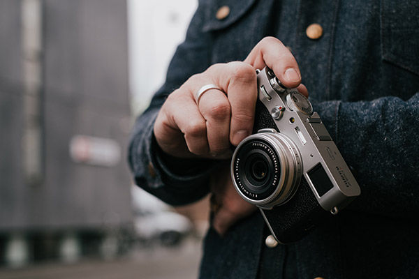 Lifestyle image holding camera while traveling